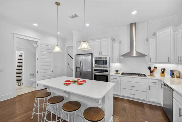 a kitchen that has a lot of cabinets and appliances