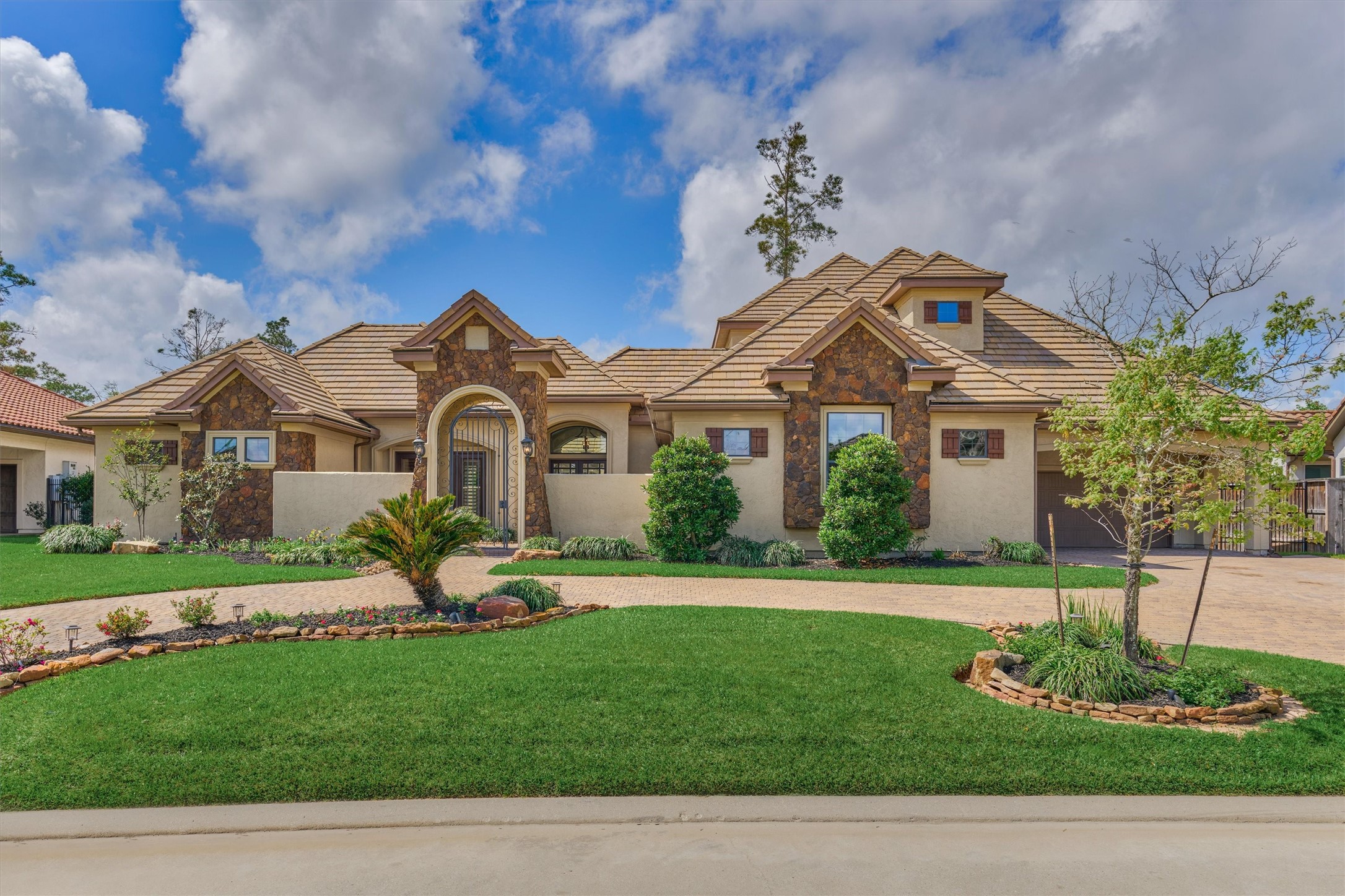25 Post Shadow Estate Drive Spring, TX 77389 - Photo 2 of 49 a front view of a house with a garden and plants