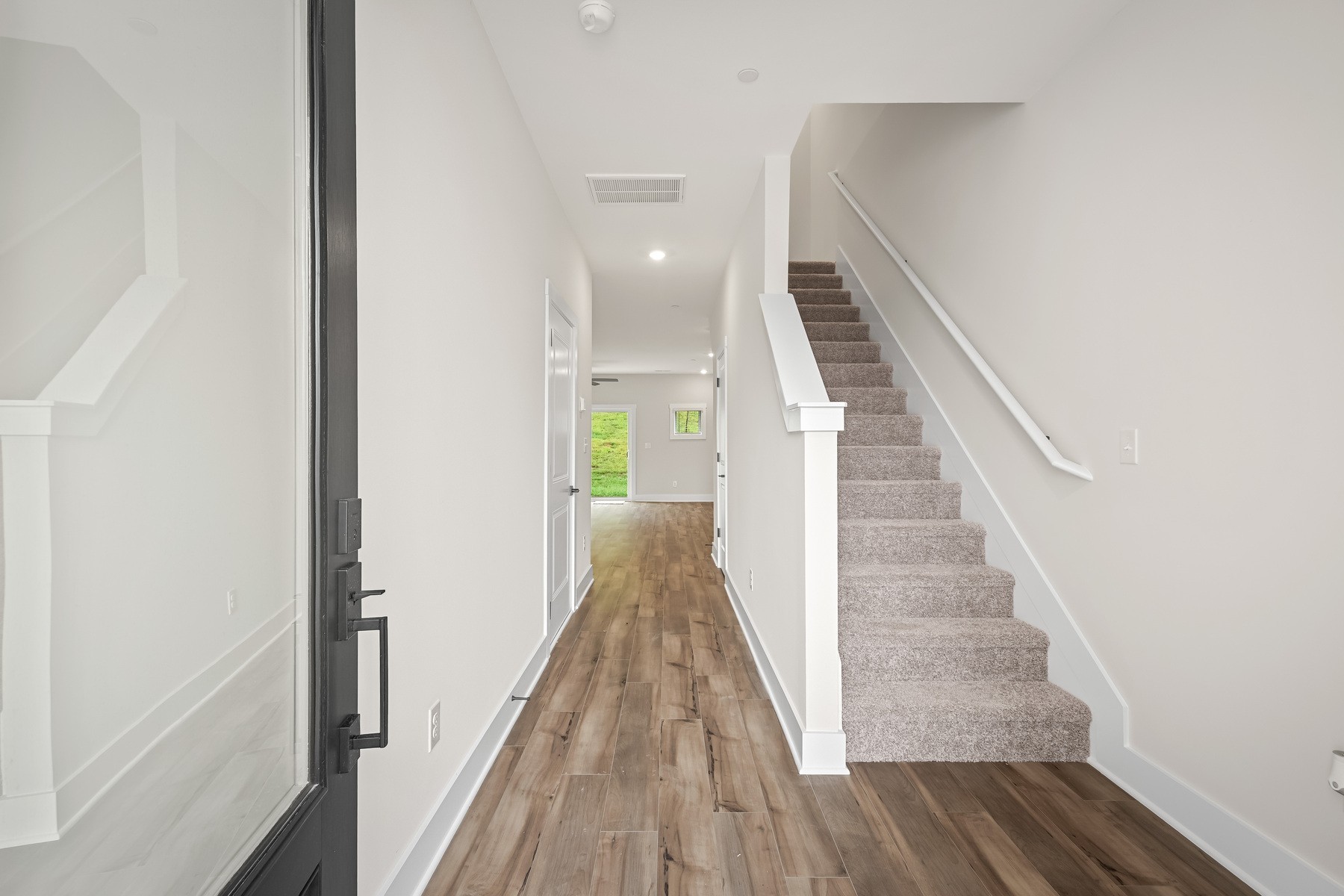 4007 Norman Drive Spring Hill, TN 37174 - Photo 3 of 12 a view of a hallway with wooden floor and staircase