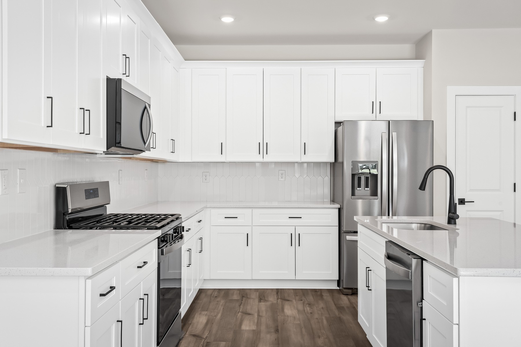 4007 Norman Drive Spring Hill, TN 37174 - Photo 7 of 12 a kitchen with stainless steel appliances granite countertop a refrigerator sink and white cabinets