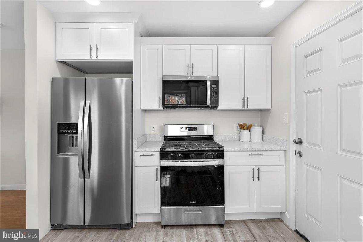 8303 Navahoe Drive Silver Spring, MD 20903 - Photo 11 of 39 a kitchen with cabinets stainless steel appliances and a counter space