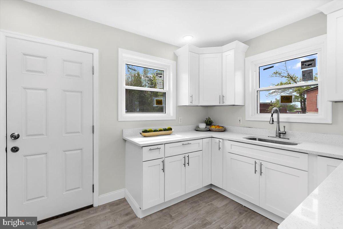 8303 Navahoe Drive Silver Spring, MD 20903 - Photo 12 of 39 a kitchen with white cabinets and white appliances