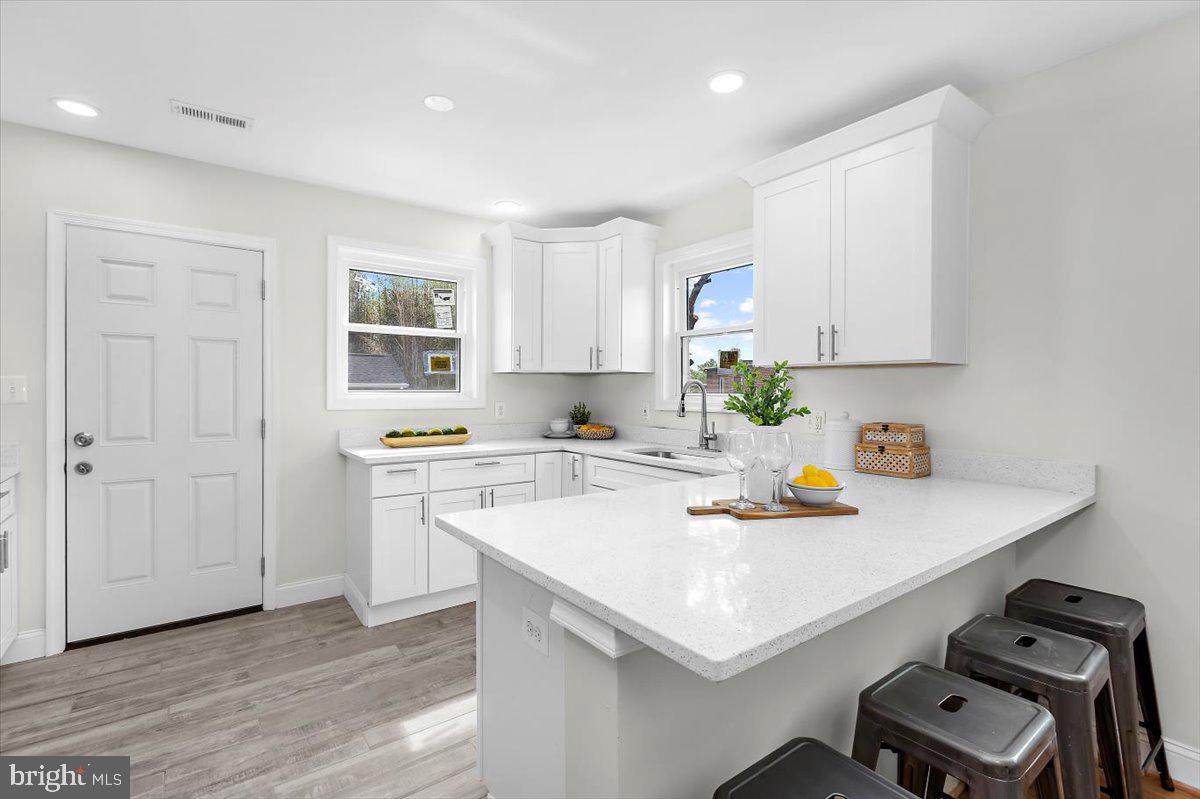 8303 Navahoe Drive Silver Spring, MD 20903 - Photo 13 of 39 a kitchen with a sink a stove and cabinets