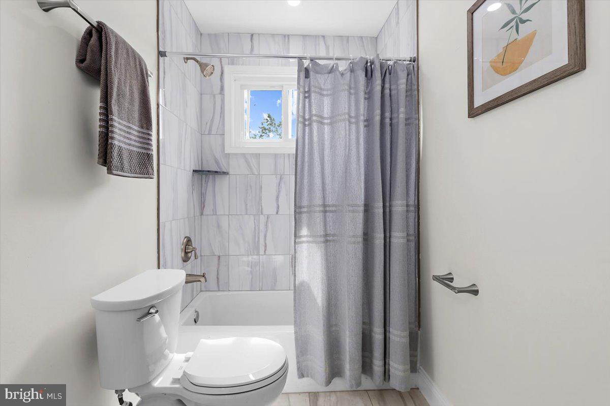 8303 Navahoe Drive Silver Spring, MD 20903 - Photo 15 of 39 a bathroom with a shower a toilet and a shower