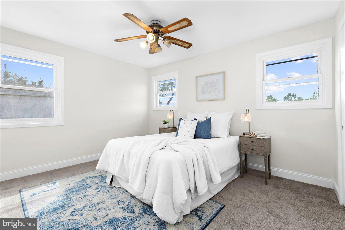 8303 Navahoe Drive Silver Spring, MD 20903 - Photo 17 of 39 a bedroom with a bed and a painting on the wall