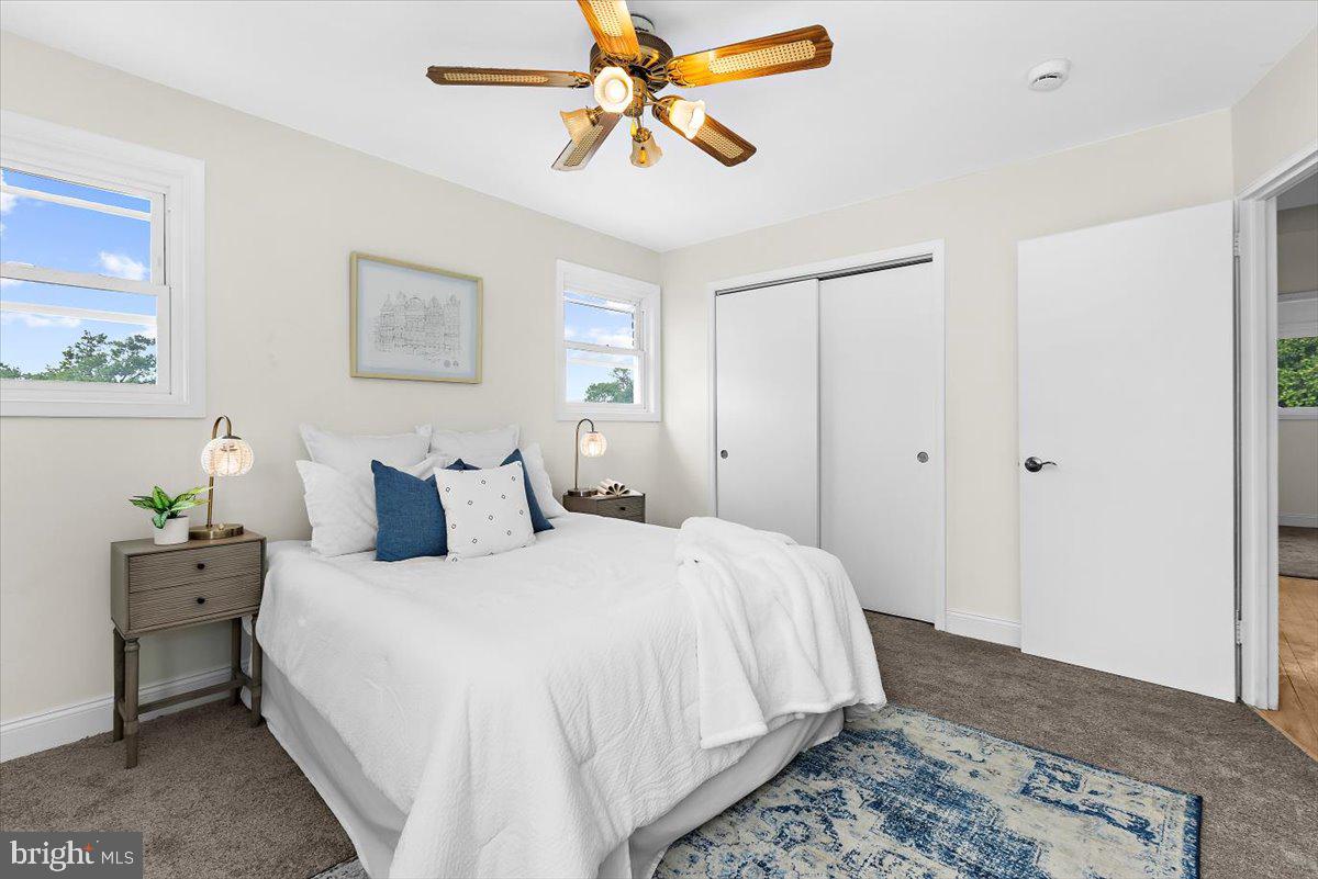 8303 Navahoe Drive Silver Spring, MD 20903 - Photo 18 of 39 a bedroom with a bed and a chandelier