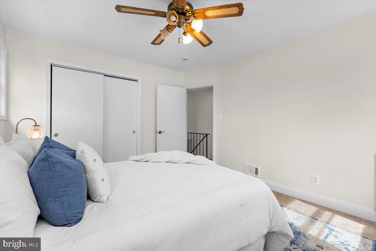 8303 Navahoe Drive Silver Spring, MD 20903 - Photo 19 of 39 a bedroom with a bed and a chandelier