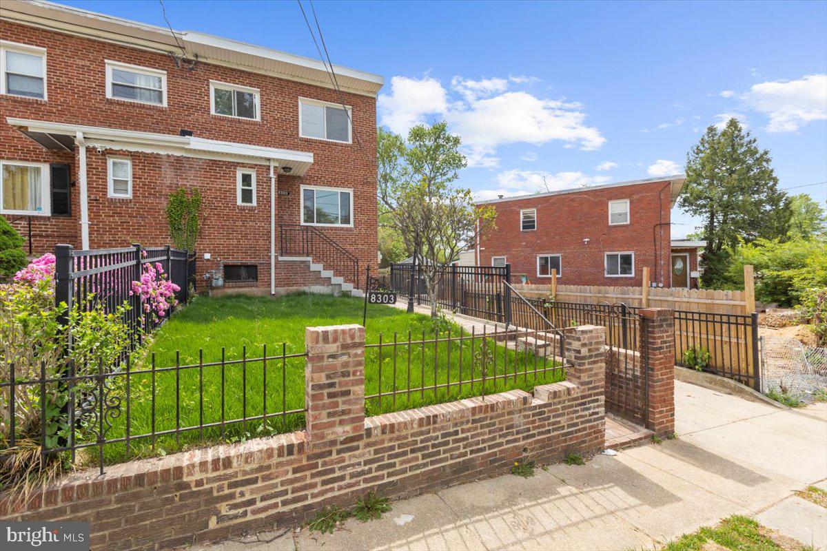 8303 Navahoe Drive Silver Spring, MD 20903 - Photo 2 of 39 a view of a brick house with a yard and table and chairs