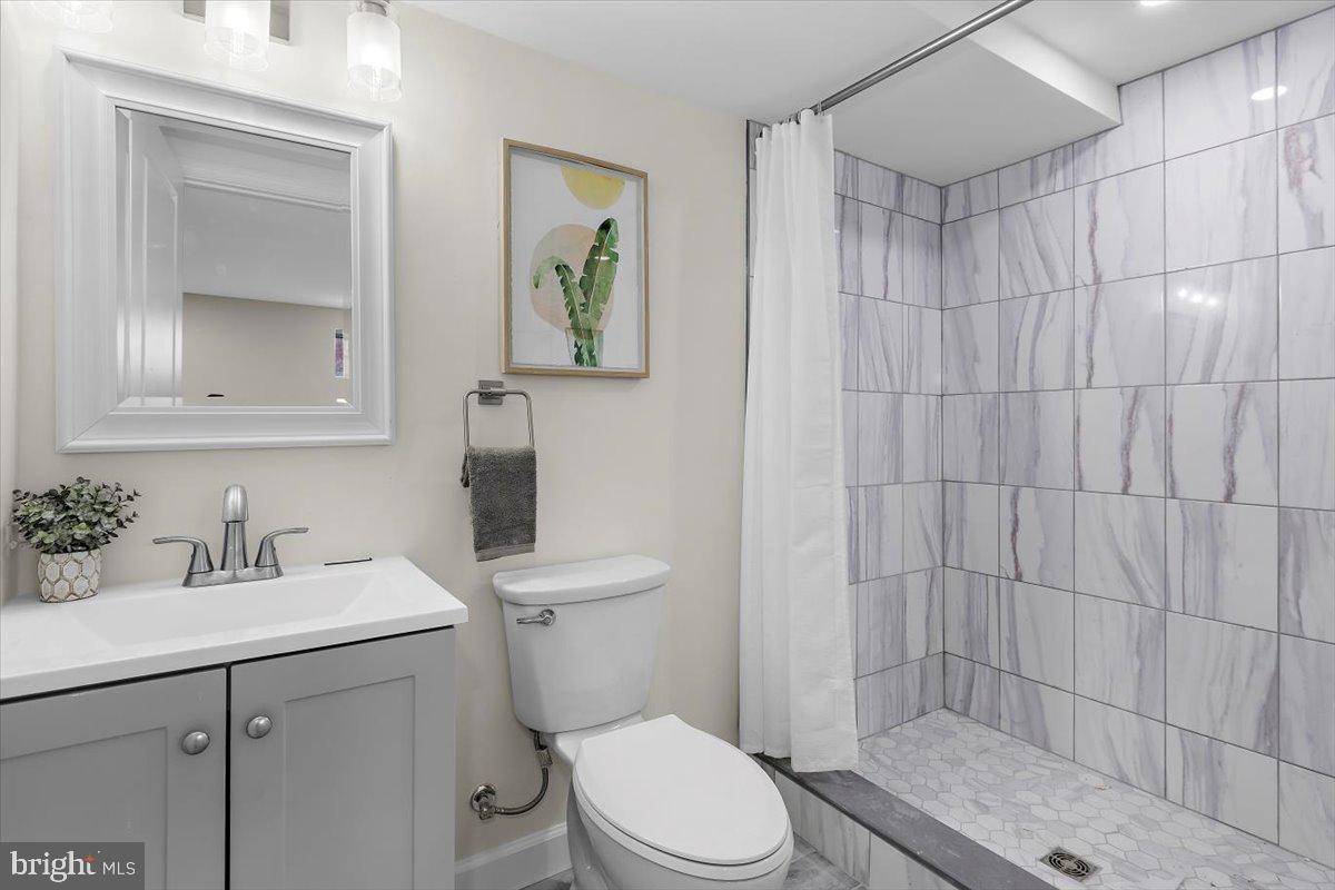 8303 Navahoe Drive Silver Spring, MD 20903 - Photo 33 of 39 a bathroom with a sink a toilet and shower