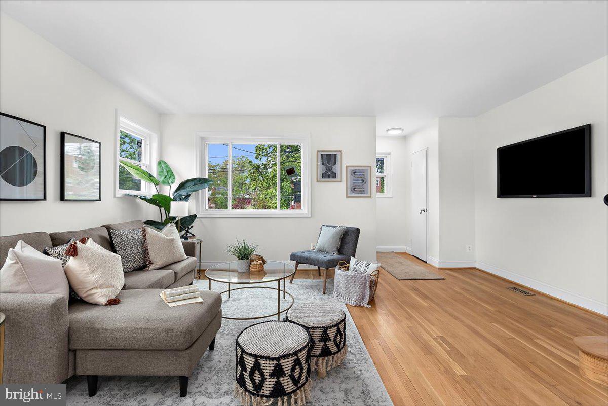 8303 Navahoe Drive Silver Spring, MD 20903 - Photo 6 of 39 a living room with furniture and a flat screen tv