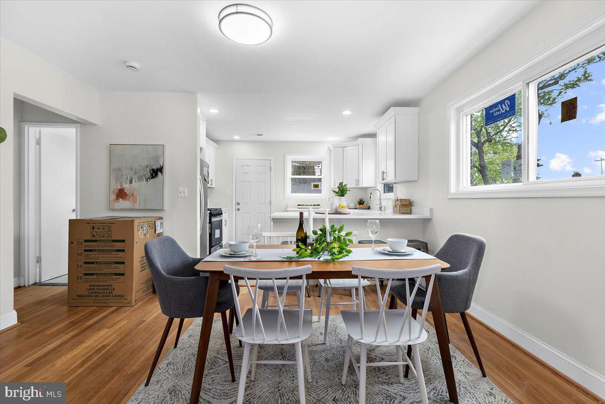 8303 Navahoe Drive Silver Spring, MD 20903 - Photo 7 of 39 a view of a dining room with furniture window and wooden floor