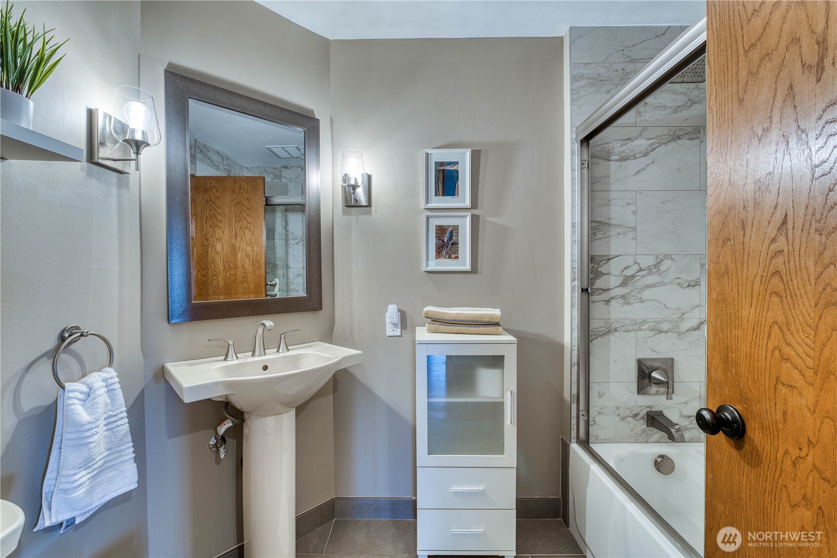 507 North 3rd Street, Unit 101 Tacoma, WA 98403 - Photo 29 of 33 a bathroom with a sink and mirror with toilet