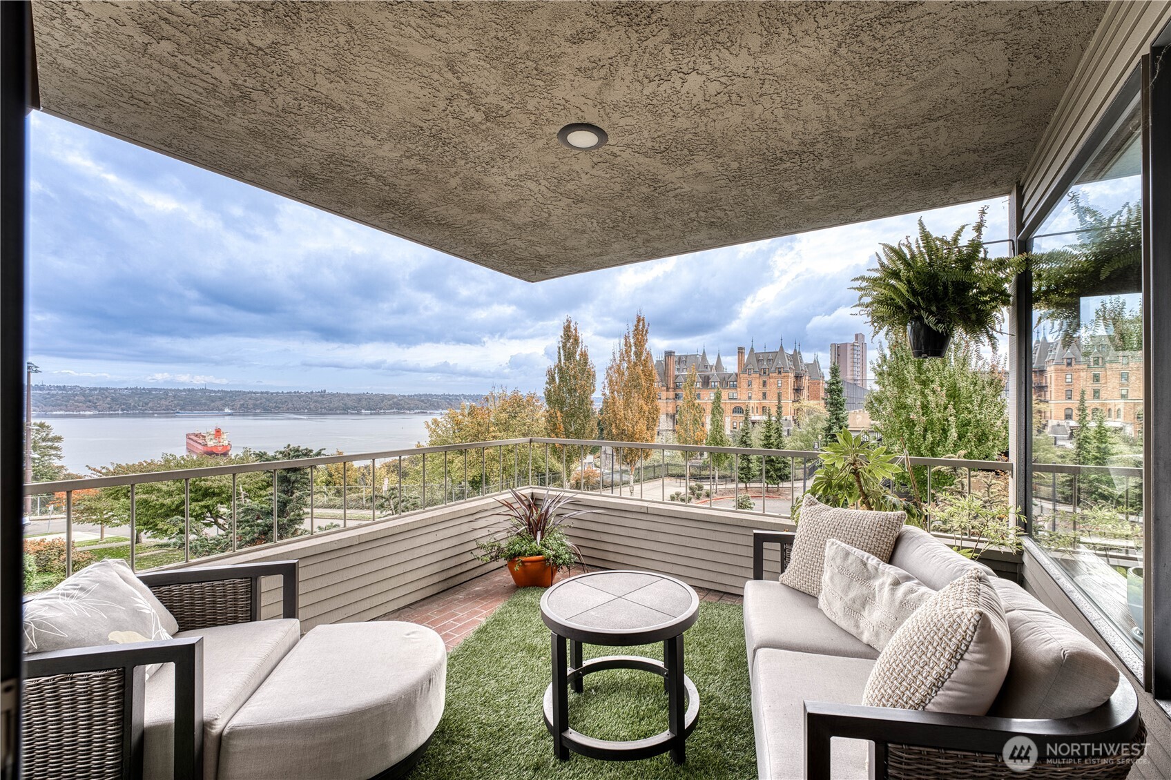 507 North 3rd Street, Unit 101 Tacoma, WA 98403 - Photo 10 of 33 a balcony with furniture and a floor to ceiling window