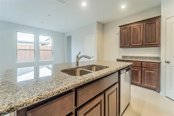 a stove top oven sitting inside of a kitchen