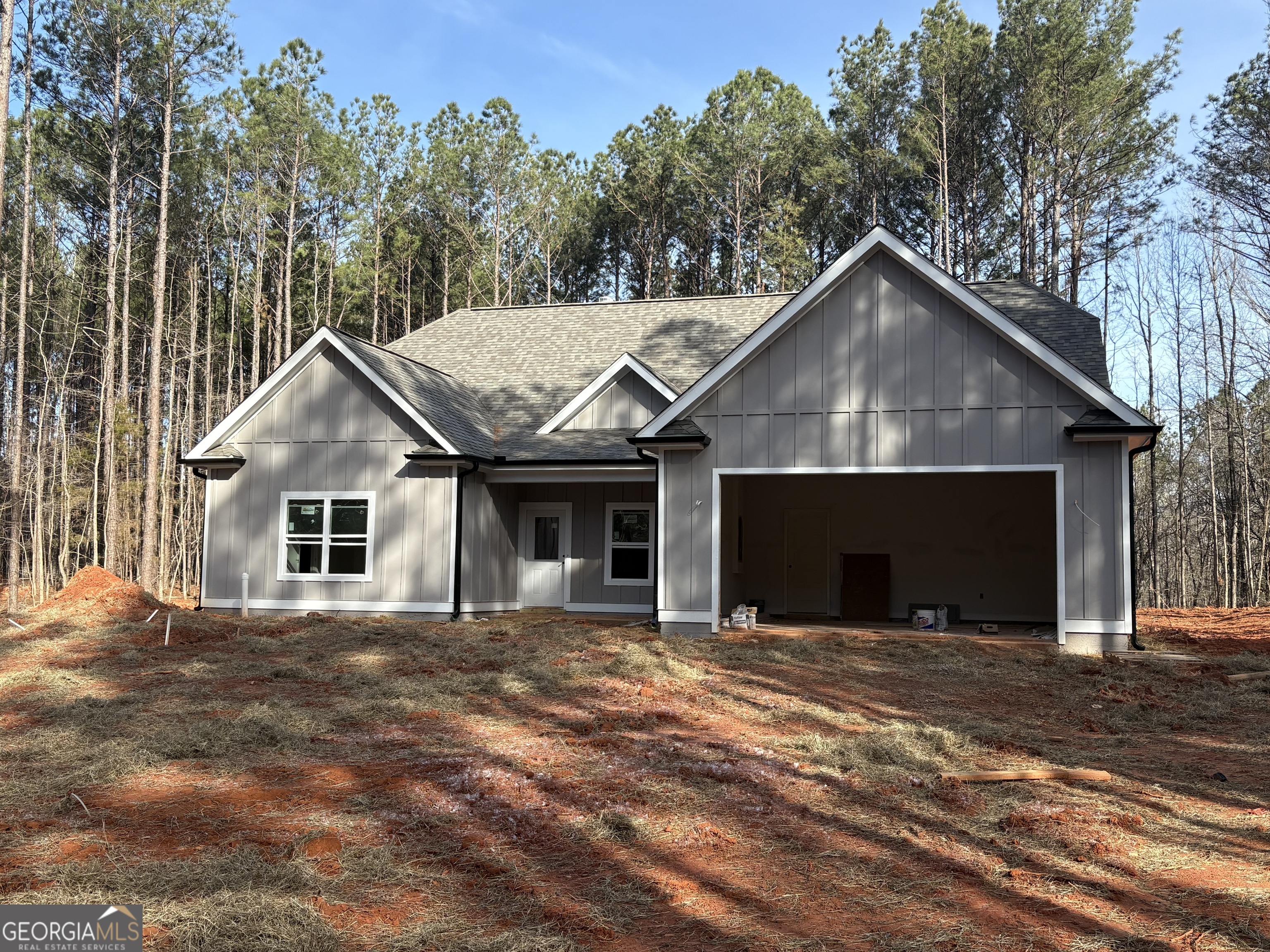 a view of a house with a yard and large tree