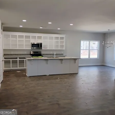 a kitchen with kitchen island a sink stainless steel appliances and cabinets