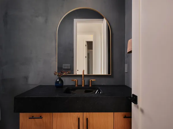 a bathroom with a tub sink and mirror