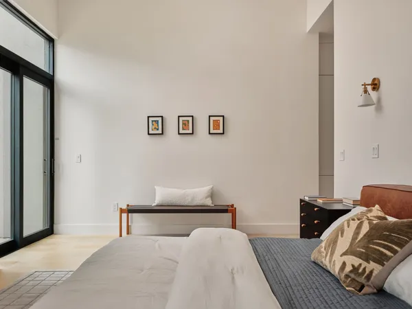 a view of a hallway to a livingroom with furniture