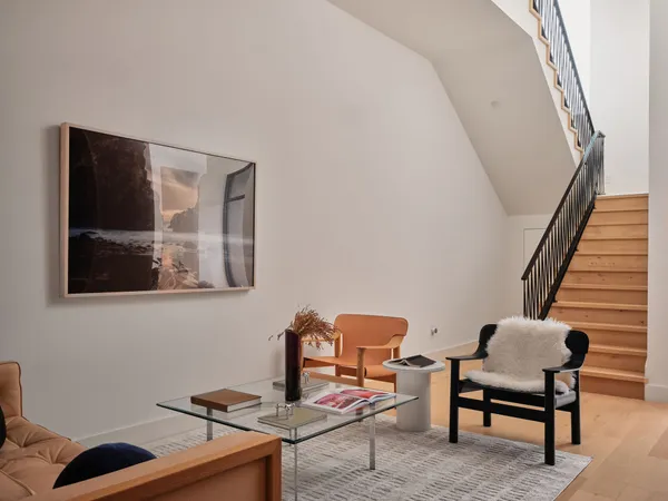 a living room with furniture large window and flat screen tv