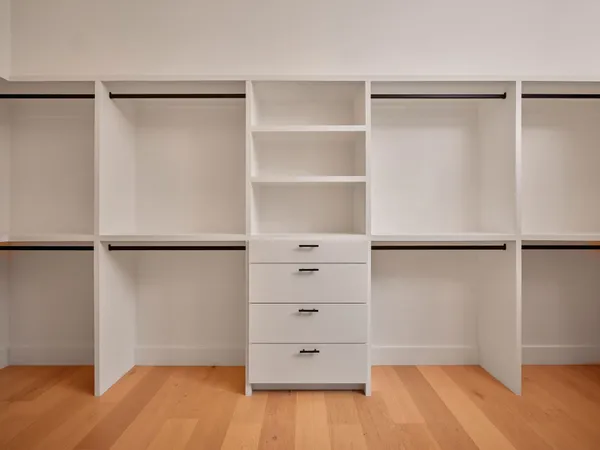a bathroom with a sink toilet vanity and shower