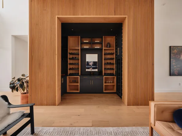 a living room with furniture and a painting on the wall