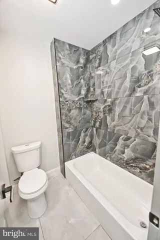 a view of a room with wooden floor and white walls