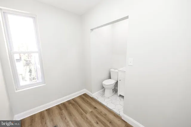 a white toilet sitting next to a sink