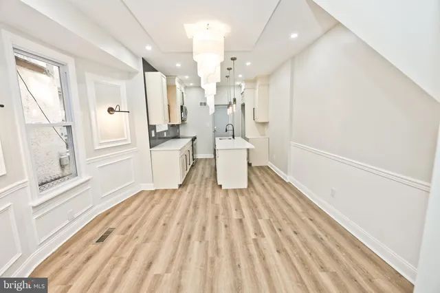 a kitchen with sink a microwave and cabinets