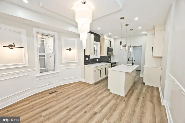 a kitchen with a sink a counter top space and appliances