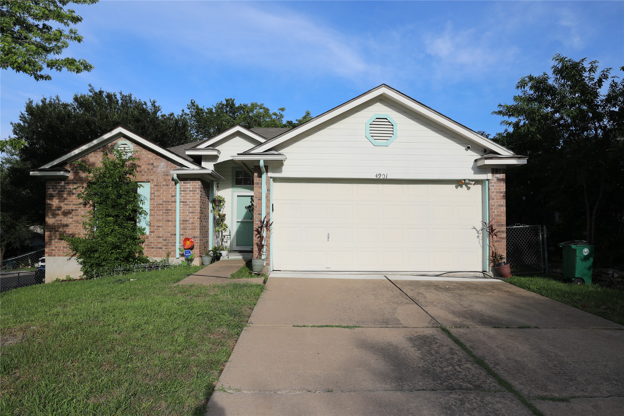 4901 Birch Creek Road Austin, TX 78744 - Photo 2 of 11 A welcoming facade showcases brick and siding accents, with a convenient attached garage.
