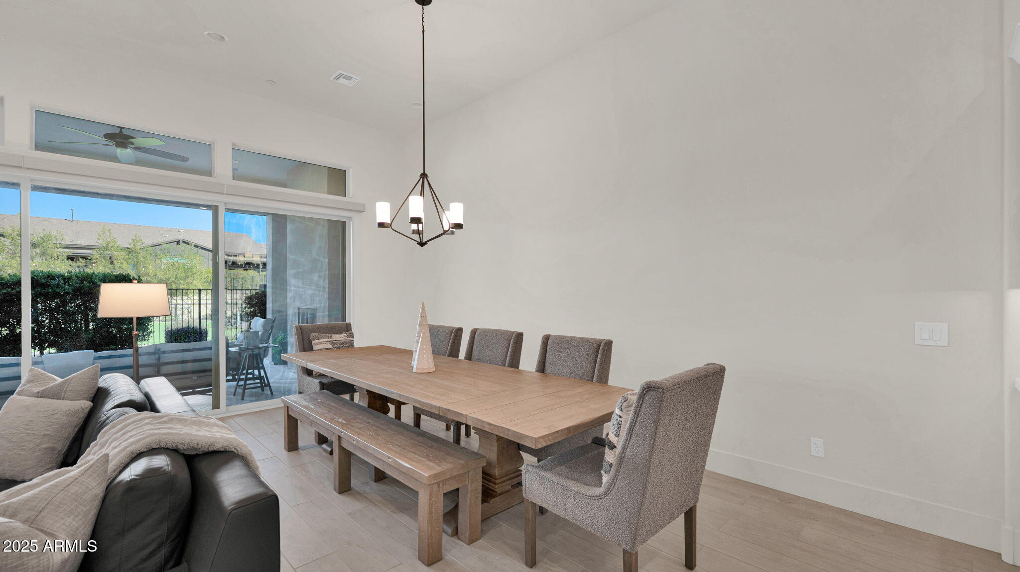 38500 North School House Road, Unit 8 Cave Creek, AZ 85331 - Photo 6 of 35 a view of a dining room with furniture wooden floor and chandelier