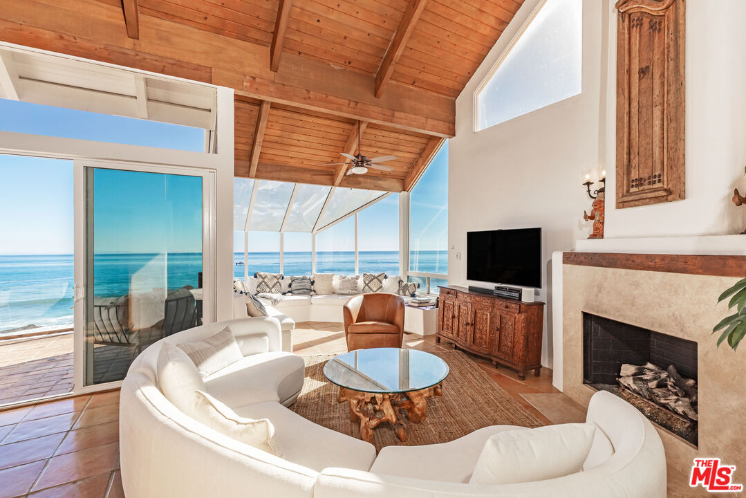 a living room with fireplace furniture and a flat screen tv