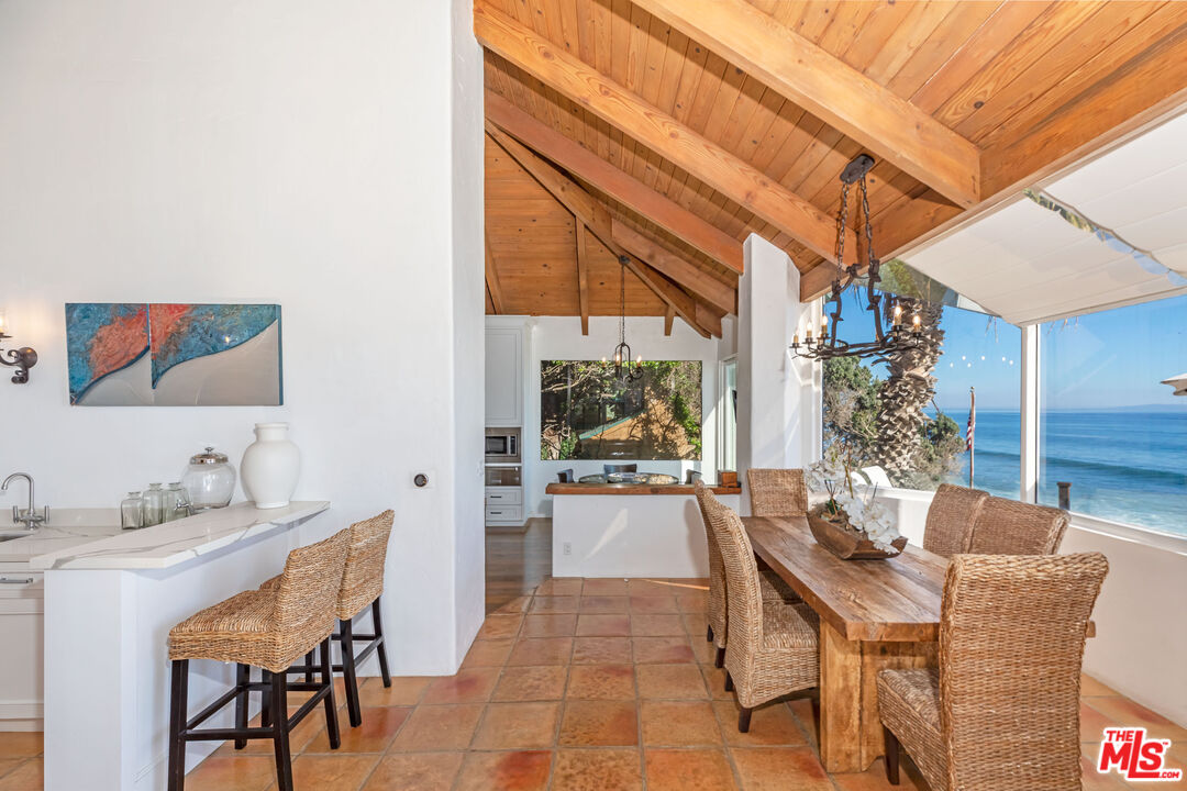24408 Malibu Road Malibu, CA 90265 - Photo 12 of 39 a dining room with furniture and wooden floor