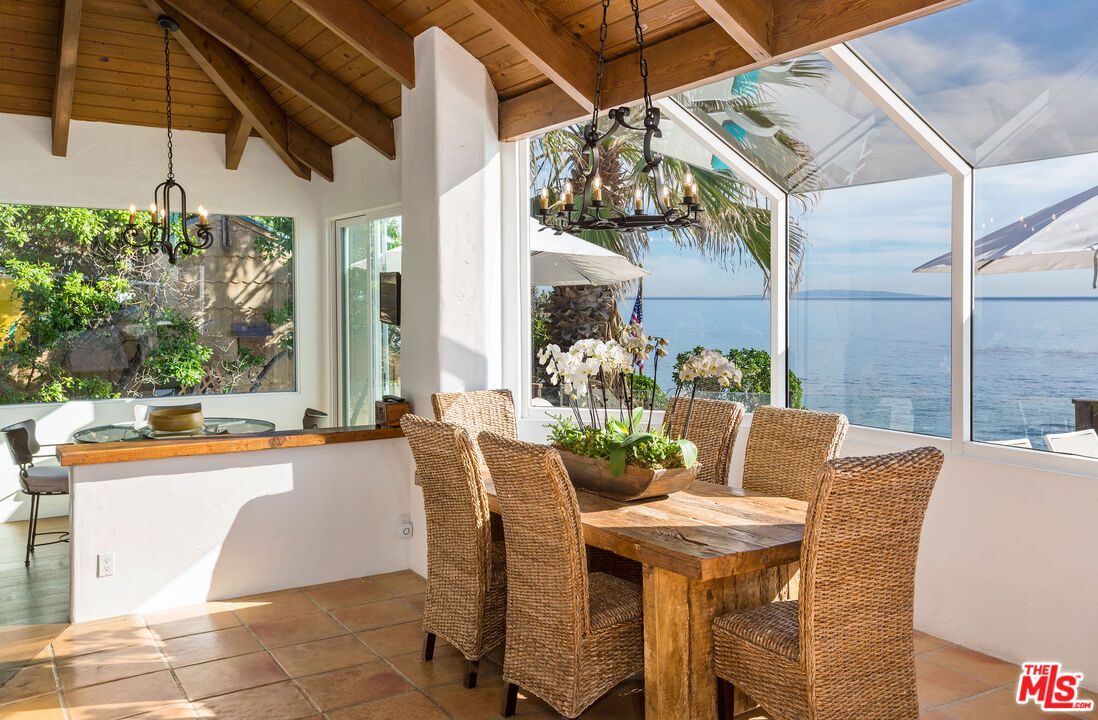 24408 Malibu Road Malibu, CA 90265 - Photo 14 of 44 a view of an outdoor dining space with a table and chairs