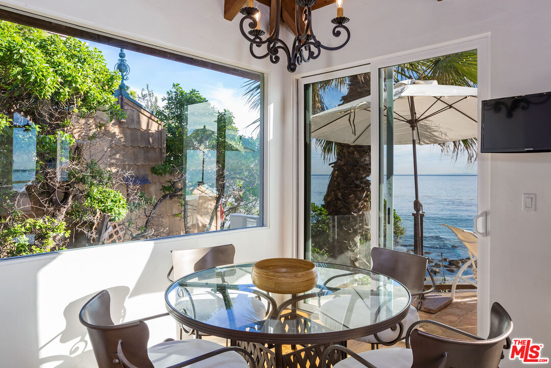 24408 Malibu Road Malibu, CA 90265 - Photo 15 of 44 a dining room with furniture and window