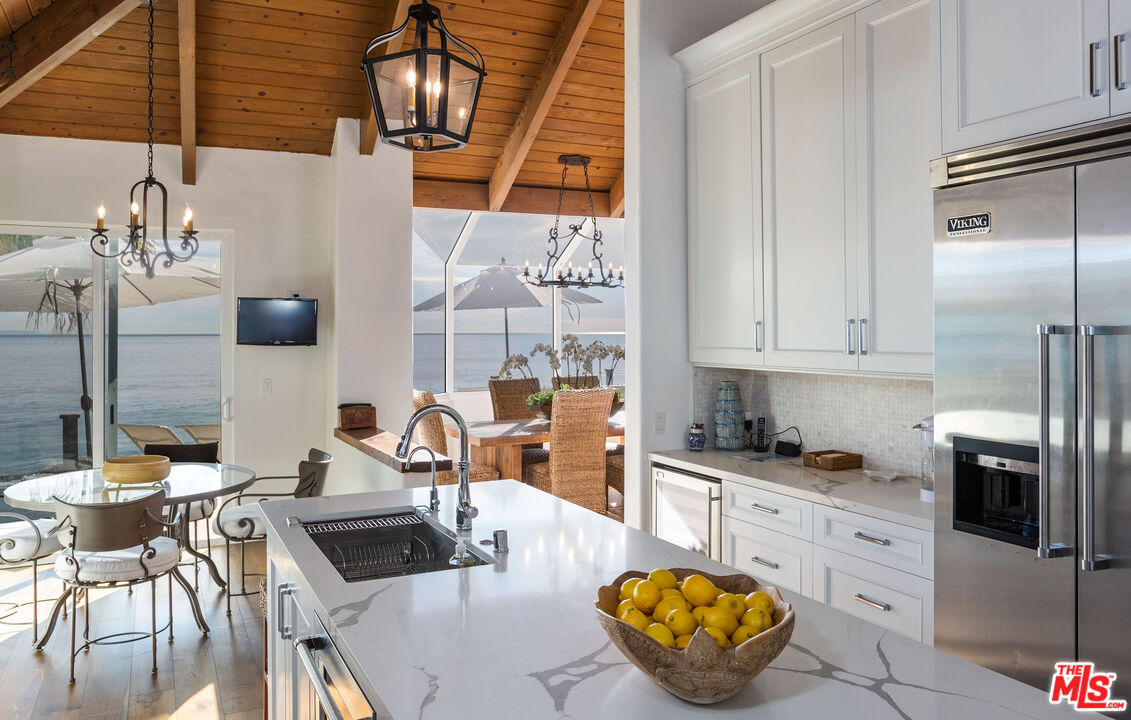 24408 Malibu Road Malibu, CA 90265 - Photo 17 of 44 a kitchen with stainless steel appliances granite countertop a sink a stove and a refrigerator