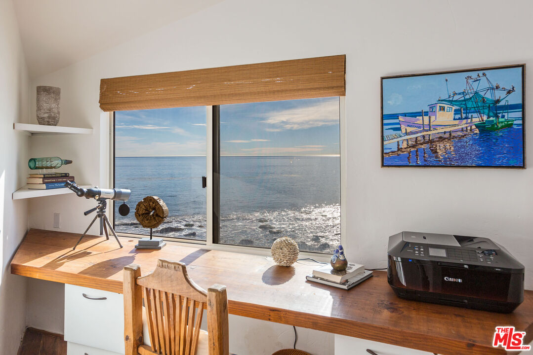 24408 Malibu Road Malibu, CA 90265 - Photo 20 of 44 a blue table sitting next to a window