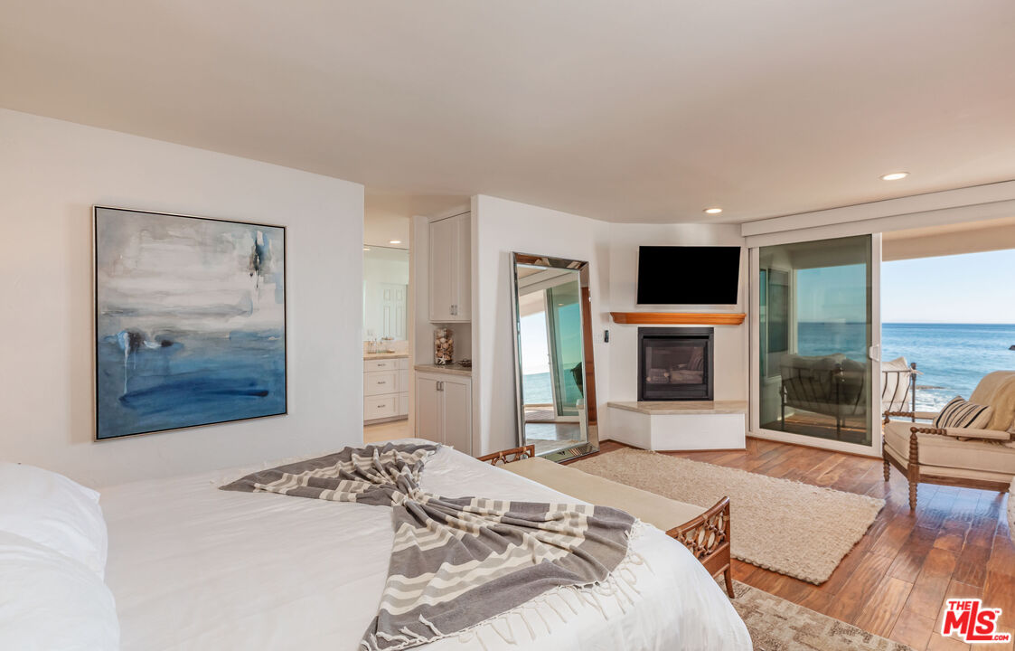 24408 Malibu Road Malibu, CA 90265 - Photo 22 of 39 a bedroom with a bed and a television