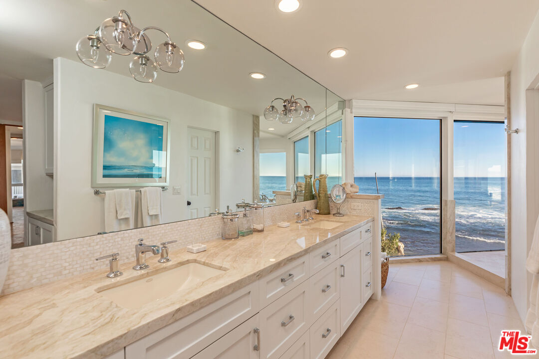 24408 Malibu Road Malibu, CA 90265 - Photo 23 of 39 a spacious bathroom with double vanity and a mirror