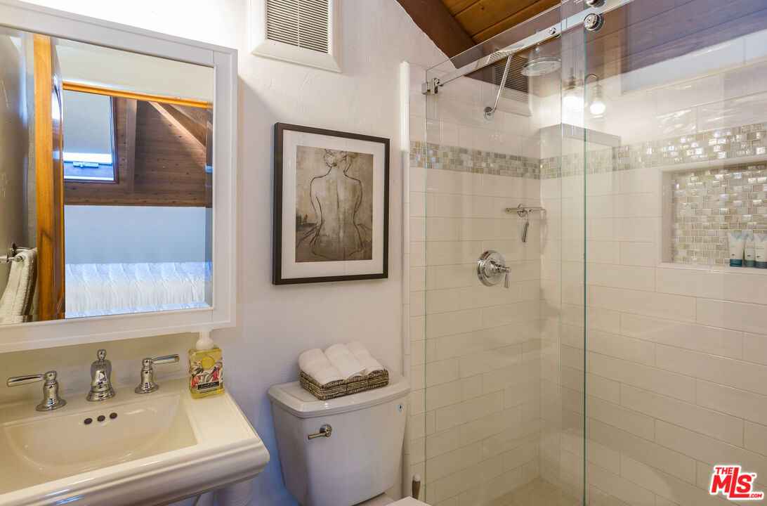 24408 Malibu Road Malibu, CA 90265 - Photo 23 of 44 a bathroom with a shower a sink and a mirror