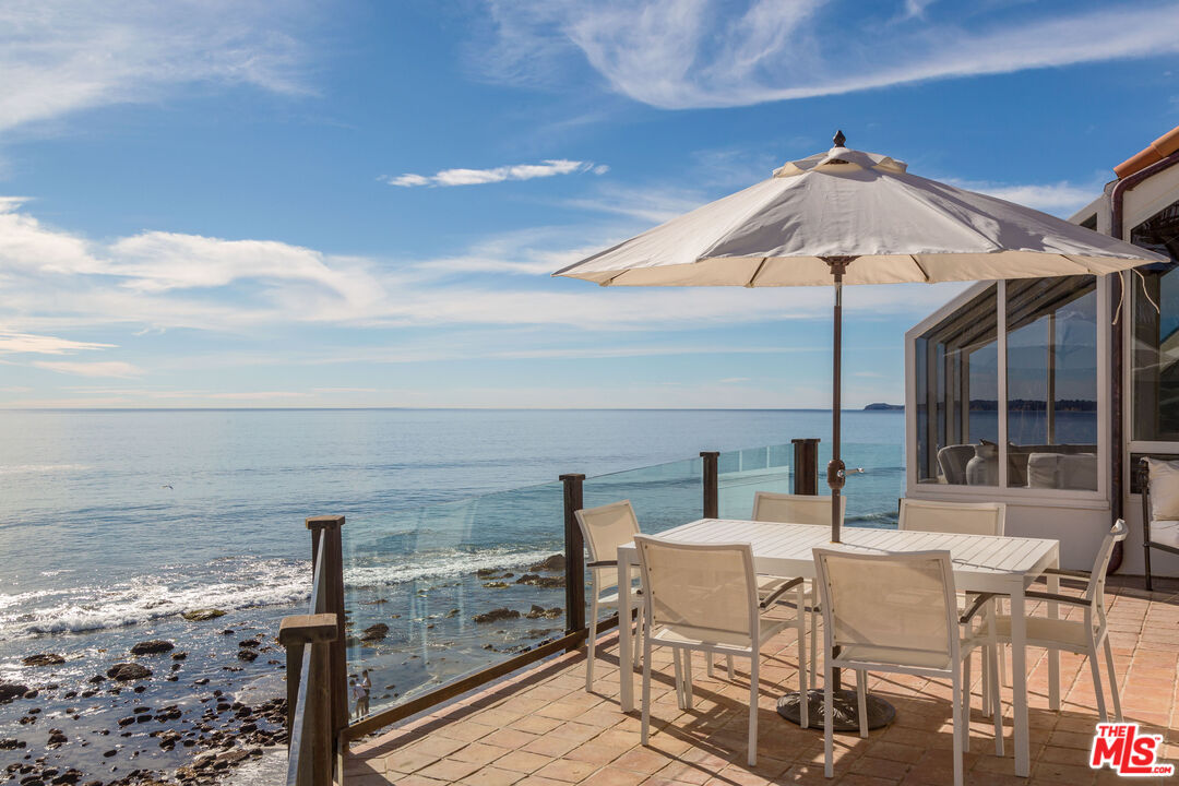 24408 Malibu Road Malibu, CA 90265 - Photo 24 of 44 a view of a terrace with furniture and stove