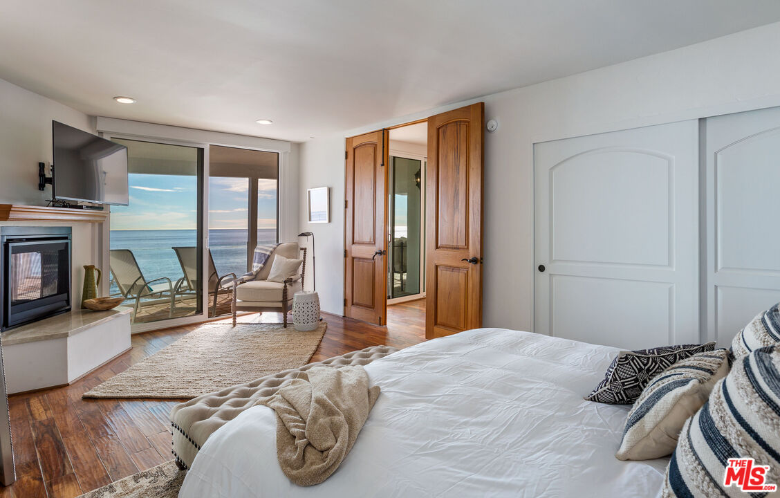 24408 Malibu Road Malibu, CA 90265 - Photo 30 of 44 a bedroom with a bed and a television