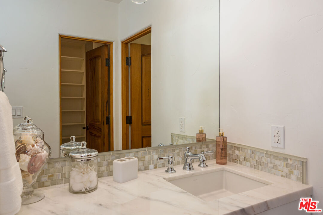 24408 Malibu Road Malibu, CA 90265 - Photo 37 of 44 a bathroom with a sink and a mirror