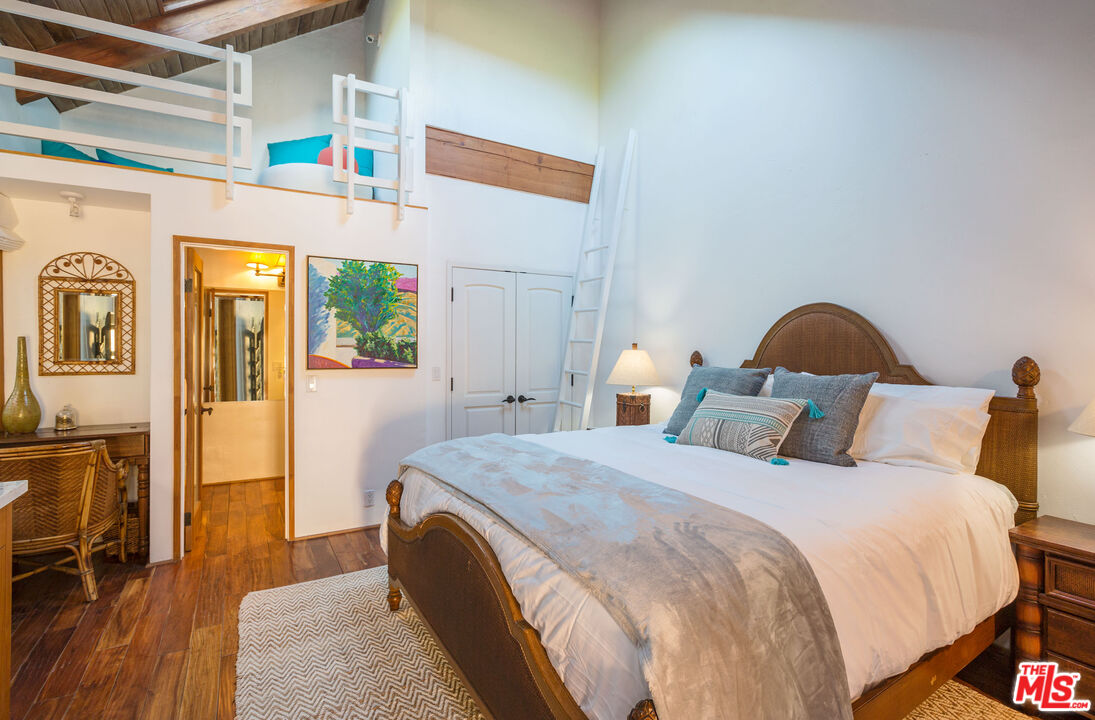 24408 Malibu Road Malibu, CA 90265 - Photo 40 of 44 a bedroom with a bed and a table