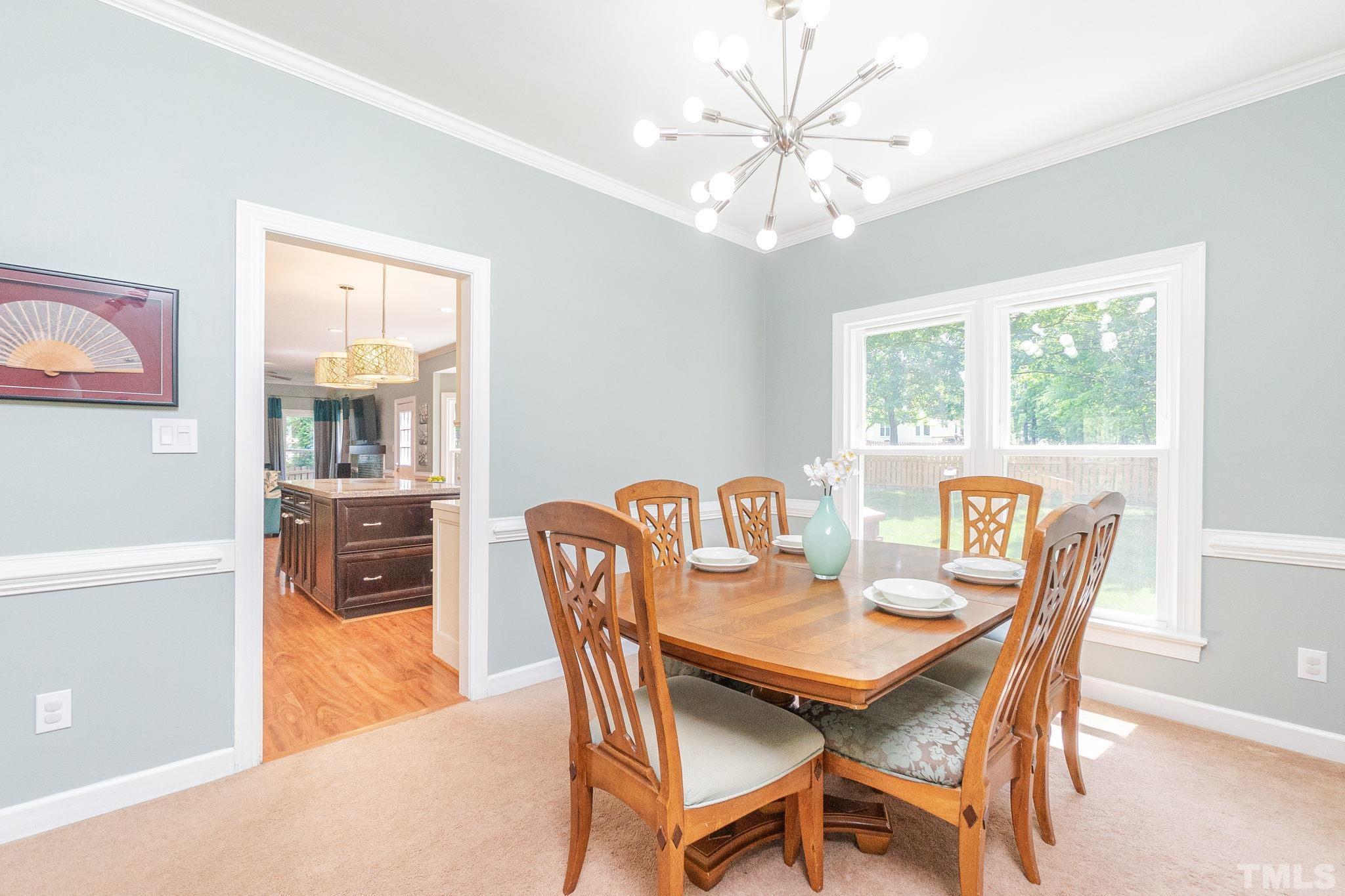 5717 Raddington Street Raleigh, NC 27613 - Photo 12 of 58 a view of a dining room with furniture window and outside view
