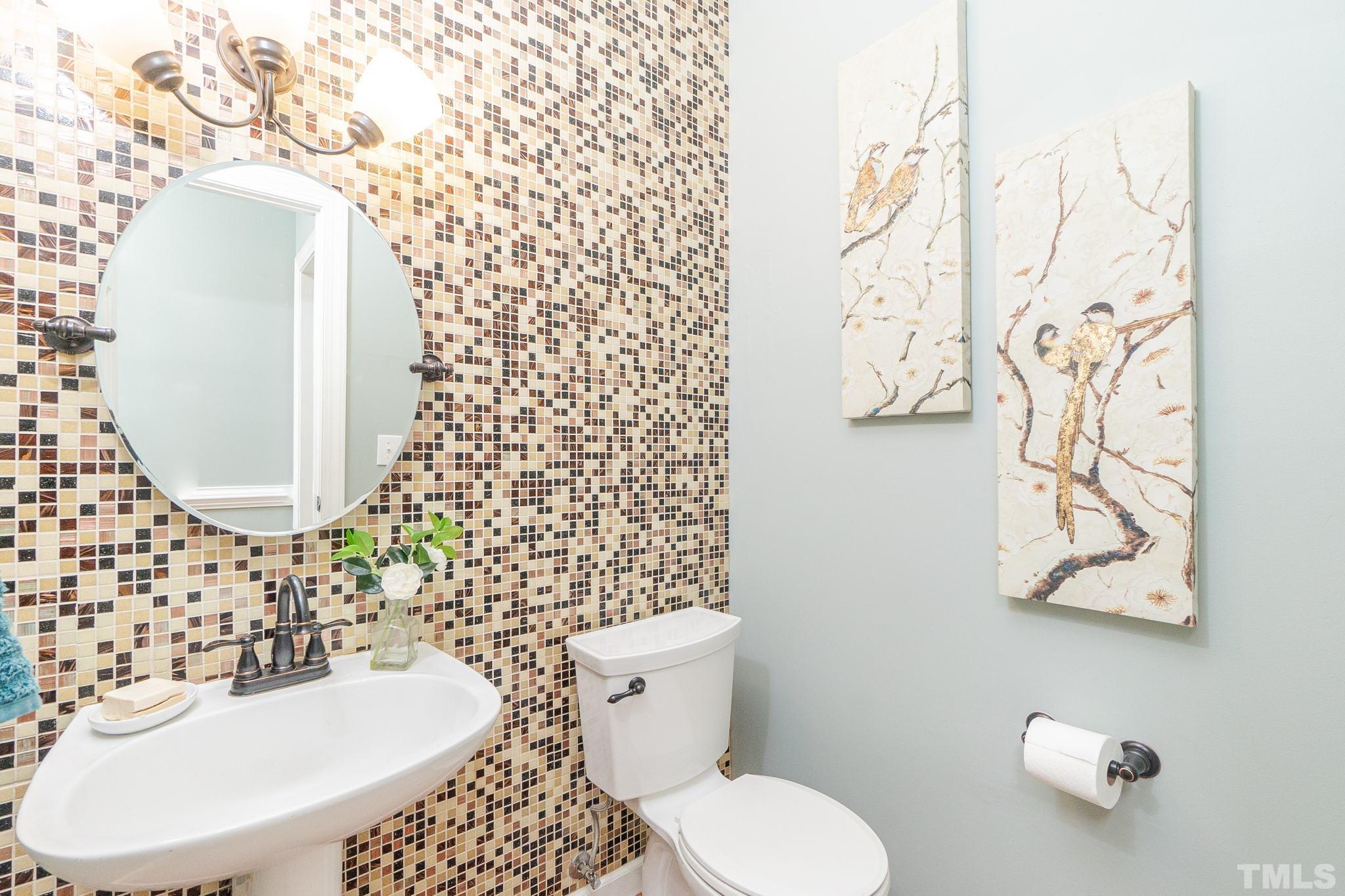 5717 Raddington Street Raleigh, NC 27613 - Photo 13 of 58 a bathroom with a toilet sink and mirror