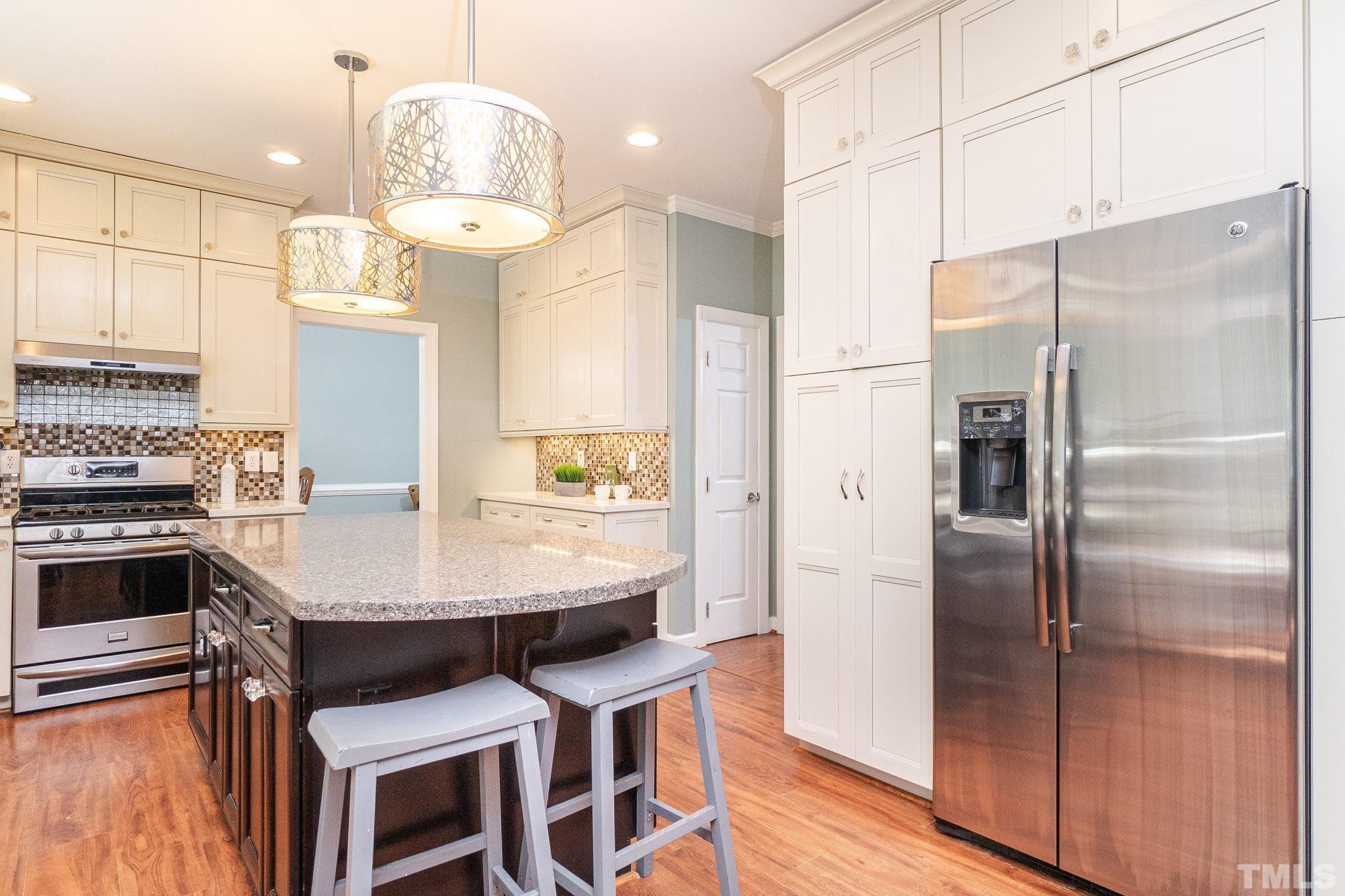 5717 Raddington Street Raleigh, NC 27613 - Photo 19 of 58 a kitchen with cabinets and stainless steel appliances