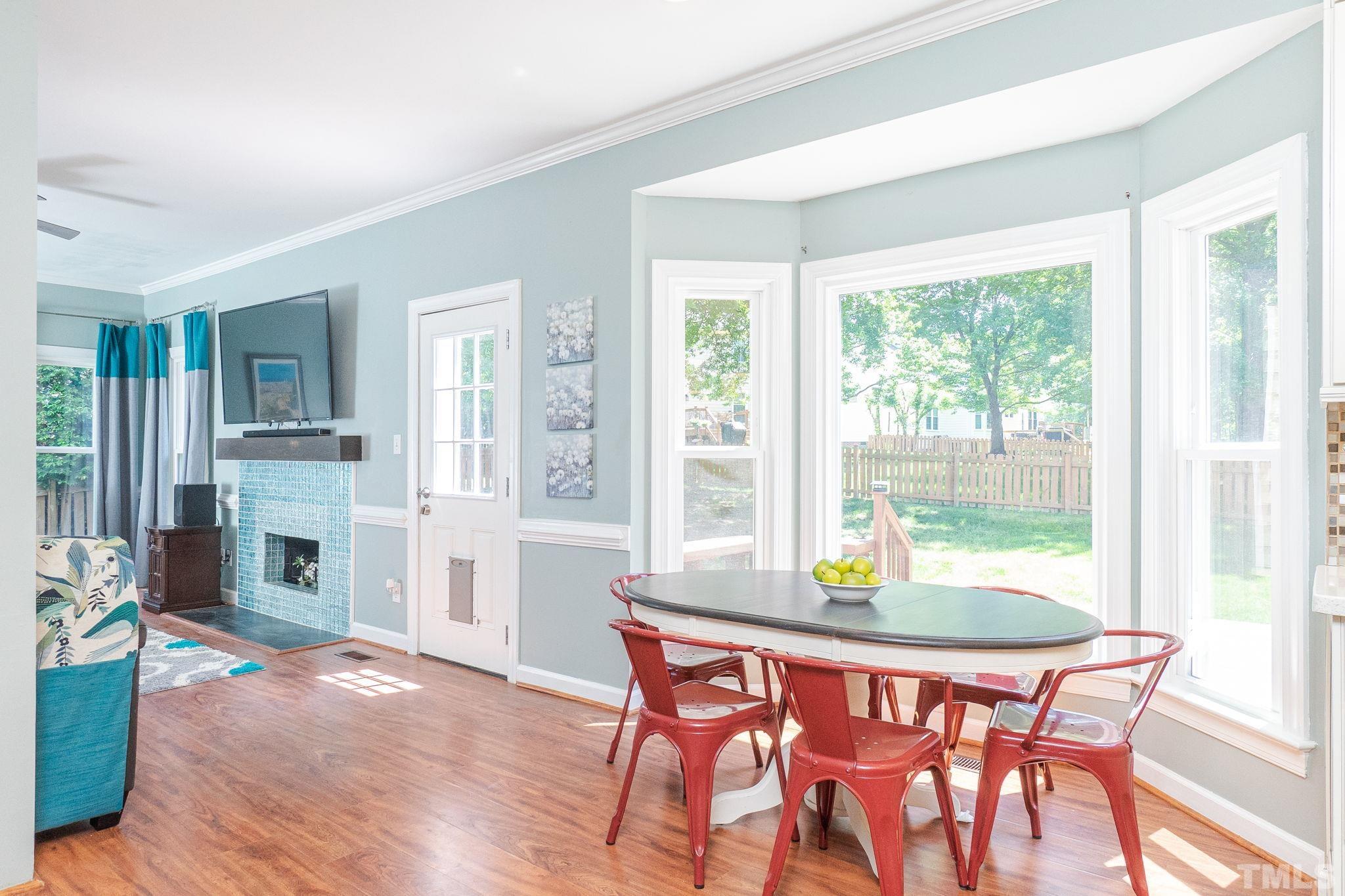 5717 Raddington Street Raleigh, NC 27613 - Photo 23 of 58 a view of a dining room with furniture window and wooden floor