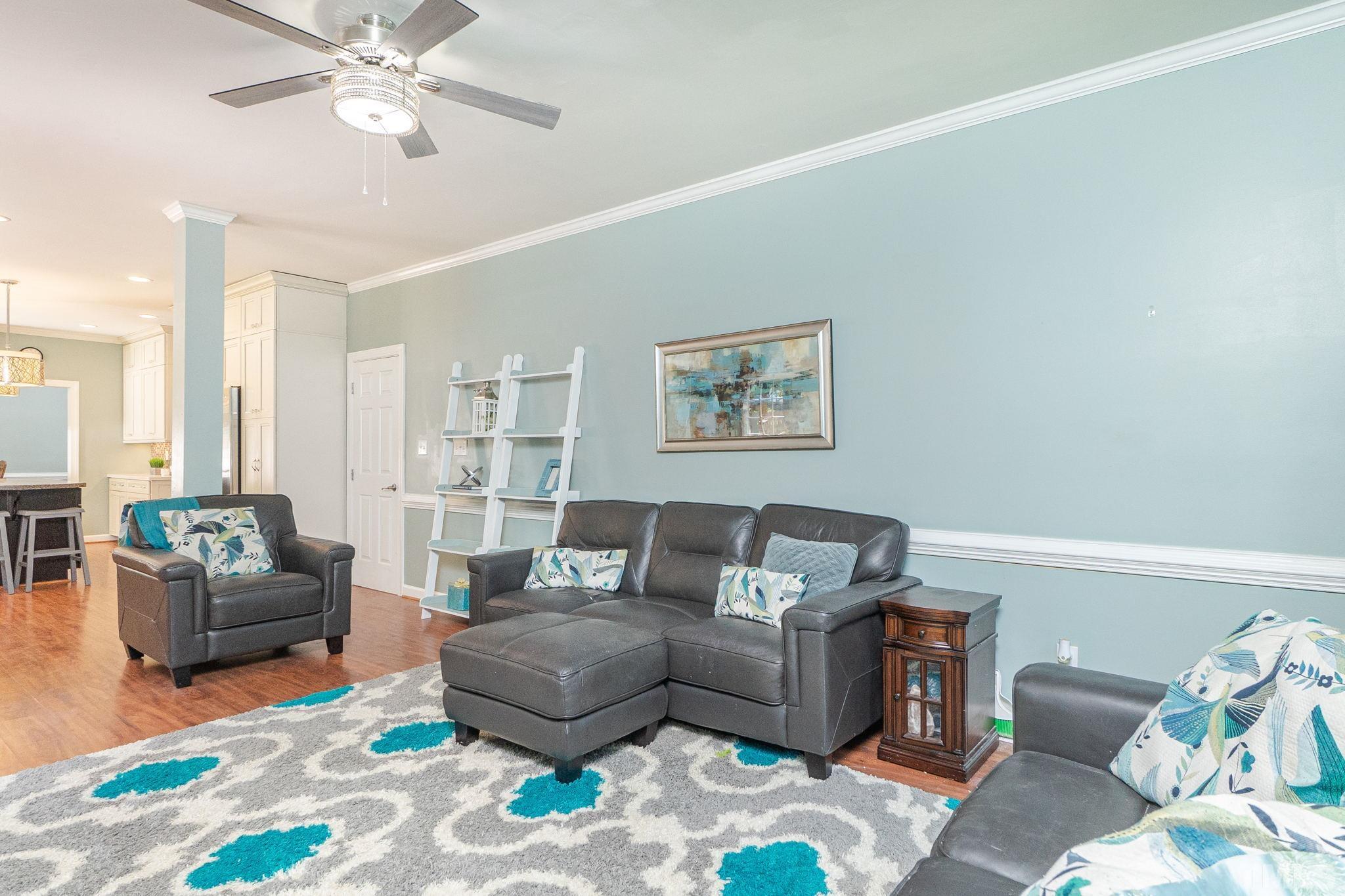 5717 Raddington Street Raleigh, NC 27613 - Photo 29 of 58 a living room with furniture and a wooden floor