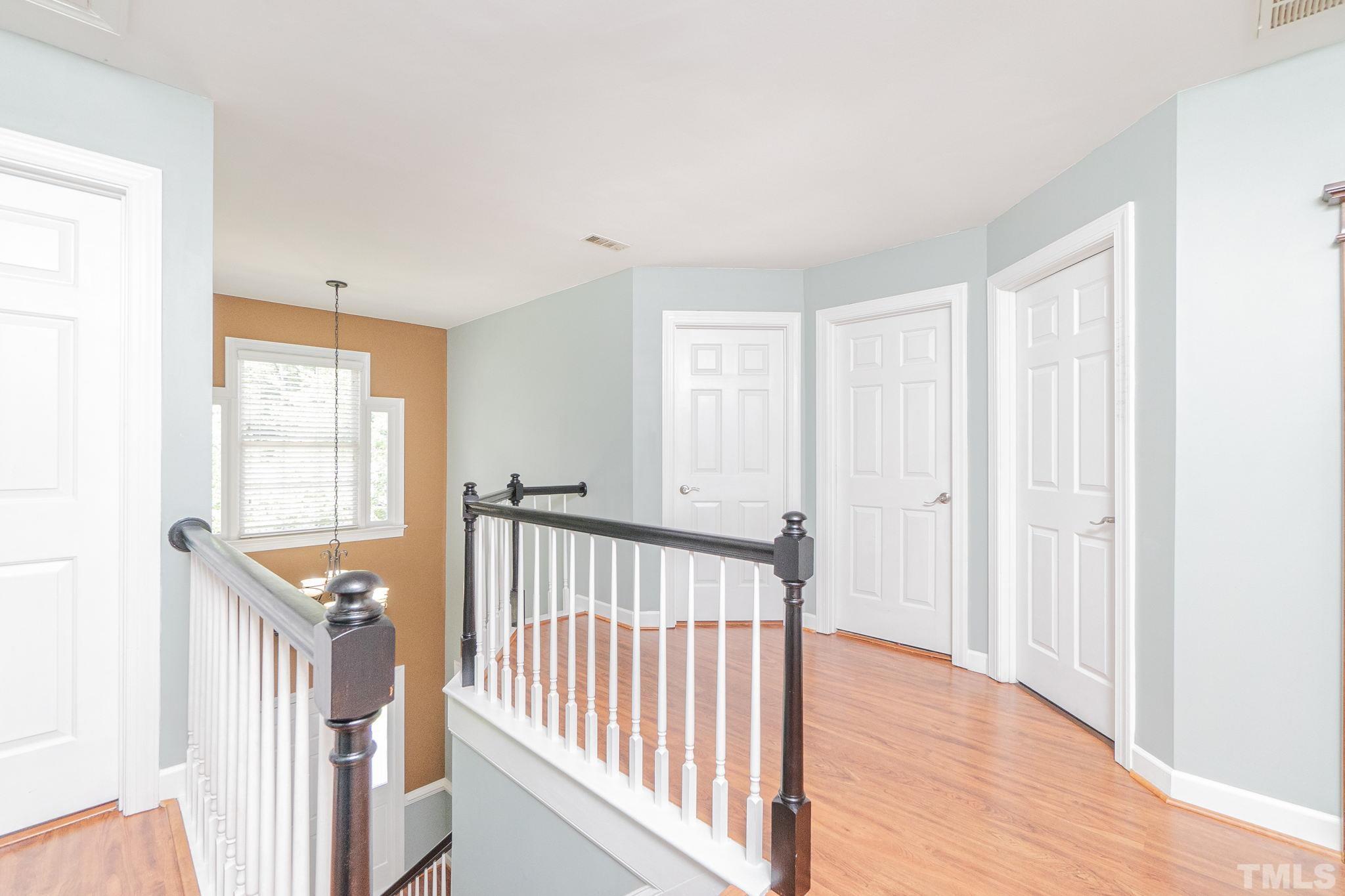 5717 Raddington Street Raleigh, NC 27613 - Photo 30 of 58 a view of a room with wooden floor and windows